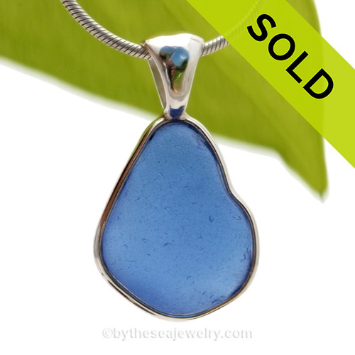 This is a beautiful and VIVID Medium Blue Sea Glass Pendant set in our Deluxe Wire Bezel© pendant setting in Sterling Silver.
This design that leaves the glass UNALTERED from the way it was found on the beach. Beautiful, Classic and Versatile.
SOLD - Sorry this Rare Sea Glass Pendant is NO LONGER AVAILABLE!
