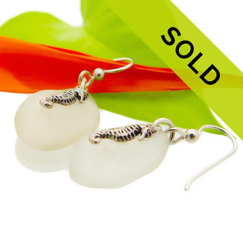 Sea glass earrings in white with sterling silver seahorse charms.