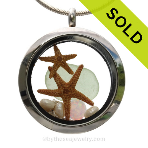 Genuine Soft Seafoam Sea Glass combined with a two real starfish pearls and a simulated Opal for and October stainless steel locket.
SOLD - Sorry this Sea Glass Locket is NO LONGER AVAILABLE!!!