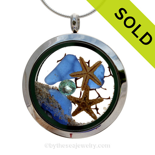 Genuine Cobalt Blue sea glass pieces combined with a two small real starfish and a bit of seafan combined with crystal aqua gem stainless steel locket.
SOLD - Sorry this Sea Glass Jewelry Selection is NO LONGER AVAILABLE!