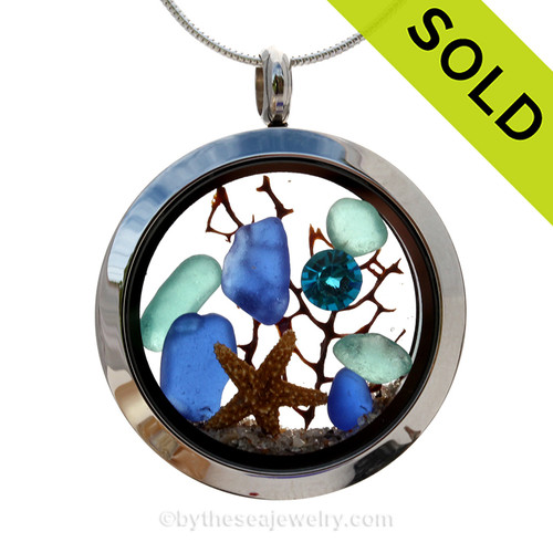 Genuine Cobalt Blue sea glass pieces combined with a small real starfish and a bit of seafan combined with crystal turquoise gem stainless steel locket.
SOLD - Sorry this Sea Glass Locket is NO LONGER AVAILABLE!