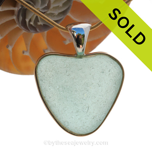 A stunning thick and frosty HUGE Seafoam Green NATURAL found sea glass heart in our deluxe wire bezel pendant setting! 
Genuine sea glass hearts are a RARE phenomena and cherished among sea glass lovers!