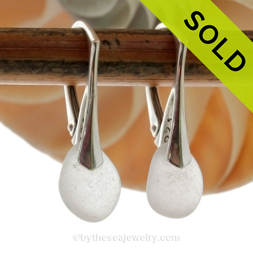 A pair of ultra petite surf tumbled beach found Genuine Sea Glass Earrings in White on solid sterling leverbacks.