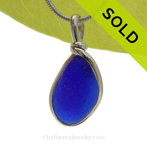A smaller yet thick piece of Cobalt Blue English Sea Glass set in our Original Deluxe Wire Bezel© necklace pendant.