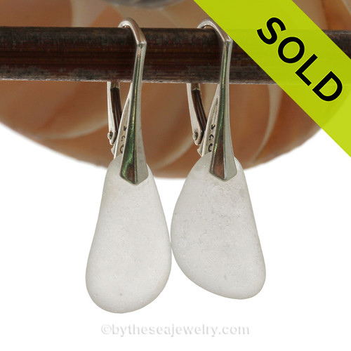 A longer pair of surf tumbled Genuine Sea Glass Earrings in White on solid sterling leverbacks.