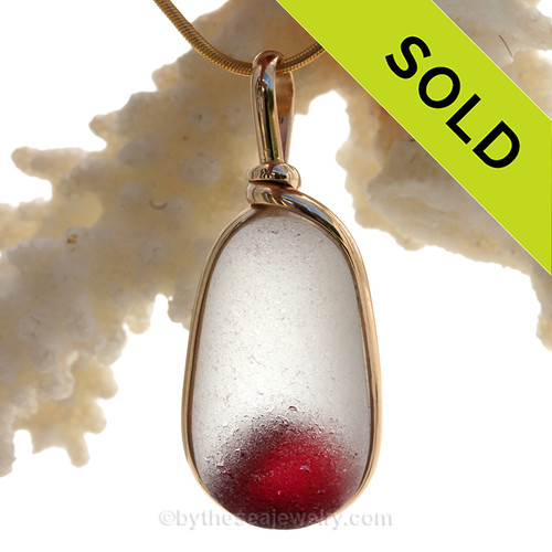A STUNNING and ULTRA RARE Hot Pink suspended inside a base of pure white in this beach found glass from Seaham England set in our Original Wire Bezel© pendant setting.

This setting is our new wire design and leaves the glass totally open and UNALTERED from the way it was found on the beach in England. Most likely this originate as the tip of a punty or pontil used in glass making. The multi color of the internal comet indicates that art glass was being made that day over 100 years ago.