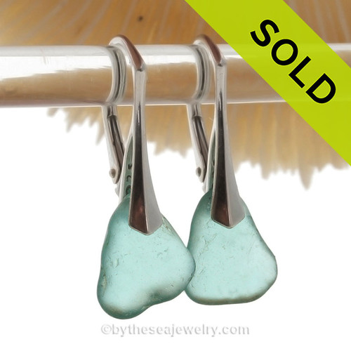 Thick Beach Found Aqua Genuine Sea Glass Earrings on Sterling Silver Leverbacks.
We meticulously sort though hundreds of pieces of beach found sea glass to find one pair that is similar in shape, size and hue!
Aqua sea glass becomes increasing as each wave passes. 