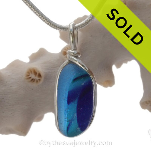 A Lovely shaped Mixed Blue Seaham multi sea glass set in Sold Sterling Silver Deluxe Wire Bezel© pendant setting.