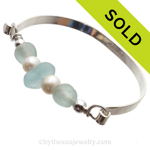 SOLD - Sorry this Sea Glass Jewelry selection is NO LONGER AVAILABLE!
A Center of beach found pale aqua blue sea glass combined with seafoam recycled glass beads and freshwater pearls on this  in this solid sterling sea glass bangle bracelet.