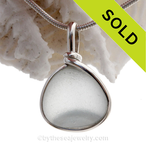 An UNUSAL mixed  Gray Blue Victorian Era Art glass perfectly encased in our Original Wire Bezel© setting in silver Sea Glass Pendant.
A stunning and rare sea glass piece perfect for any sea glass lover