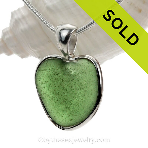 A small natural seaweed  green sea glass heart set in our Deluxe Wire Bezel©
A great necklace for any time of year and perfect for any sea glass lover!