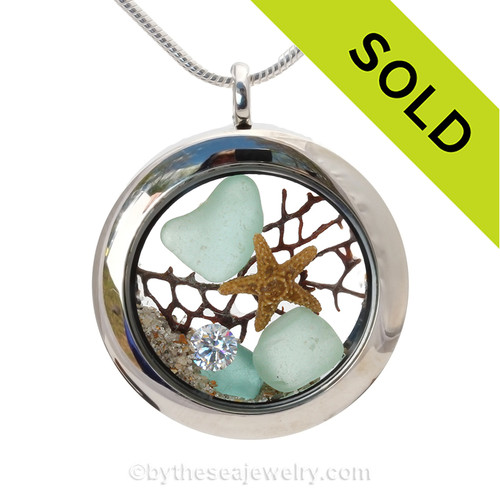 Beautiful Aqua Blue Genuine Sea Glass Locket with a real starfish and beach sand, finished with a vivid brilliant cut CZ gem "Diamond" great for any April Beach Baby!