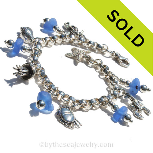 Bright Blue Genuine Sea Glass Bracelet.
Amazing Chunky real sea glass pieces are combined with solid sterling charms on a fully soldered bracelet.
Charms include lobster, jellyfish, seahorse, Welk shell, crabs and a starfish.