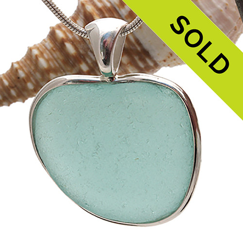 A beautiful stunning Aqua Blue natural Sea Glass Heart Pendant set in our Deluxe Wire Bezel© setting in Solid Sterling Silver.