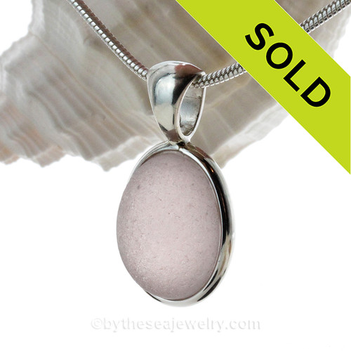 A lovely lavender or purple sea glass from Seaham England set in our Solid Sterling Silver Deluxe Wire Bezel pendant setting.