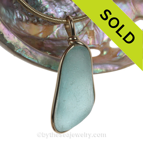 A larger piece of bright Aqua Blue Sea Glass in our signature Original Wire Bezel© pendant setting in 14K Goldfilled. This setting leaves both front and back open and the glass unaltered from the way it was found on the beach.