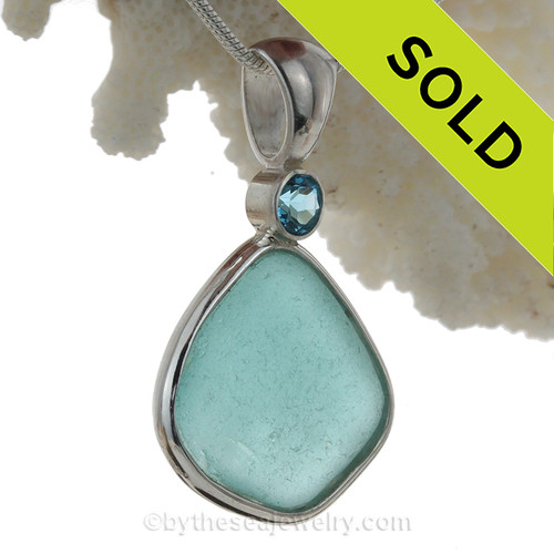 A LARGE PERFECT piece of top quality Vivid Aqua sea glass pendant set with a large Blue Topaz gem in a tube bezel setting.