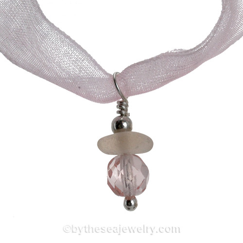 A stunning piece of peach depression glass combine with a vintage cut crystal pink bead.