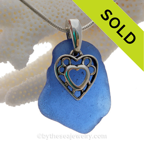 A  nice cobalt blue genuine sea glass with a solid sterling bail and detailed heart in heart charm.