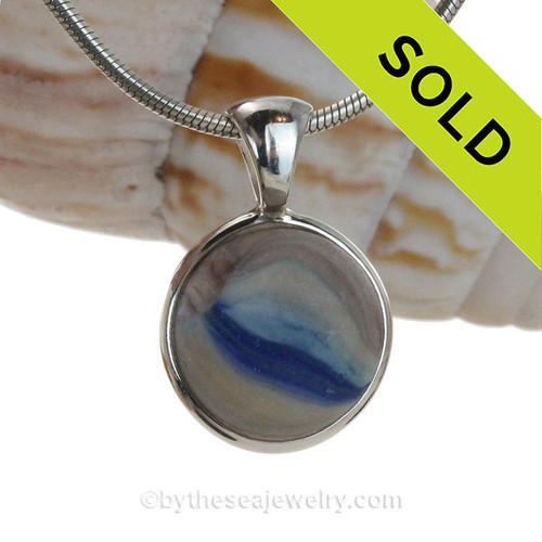 A pretty painterly sea glass marble mixed with opaque glass in our Deluxe Wire Bezel© pendant setting.