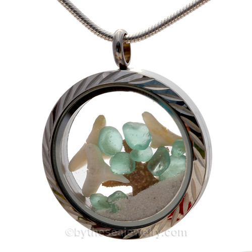 Three white sun bleached sharks teeth and tropical aqua sea glass in this fun to wear sea glass locket necklace.