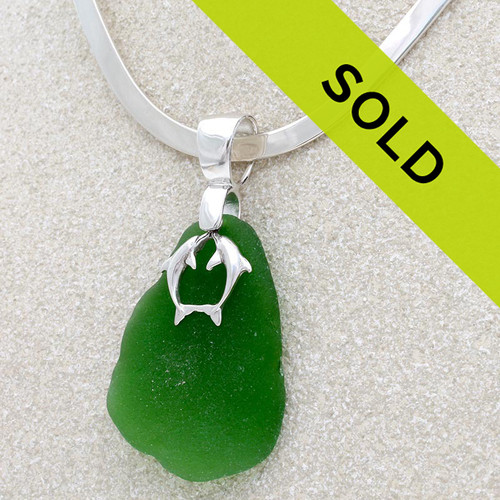 A HUGE vivid green sea glass piece with solid sterling kissing dolphins.
Sorry this necklace has sold!