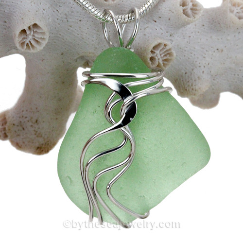 A nice Good QUALITY piece of yellowy seafoam green sea glass set in our signature Waves© setting in sterling silver.