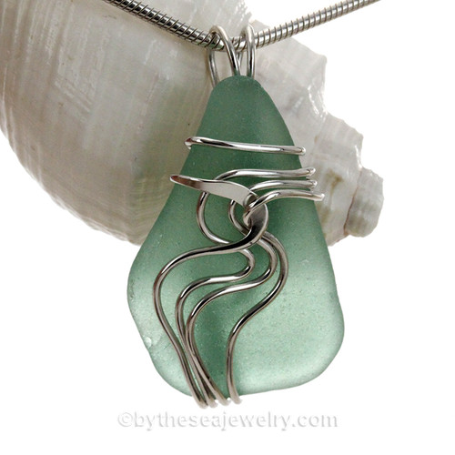 An aqua green sea glass set in our signature Waves© setting in sterling silver.