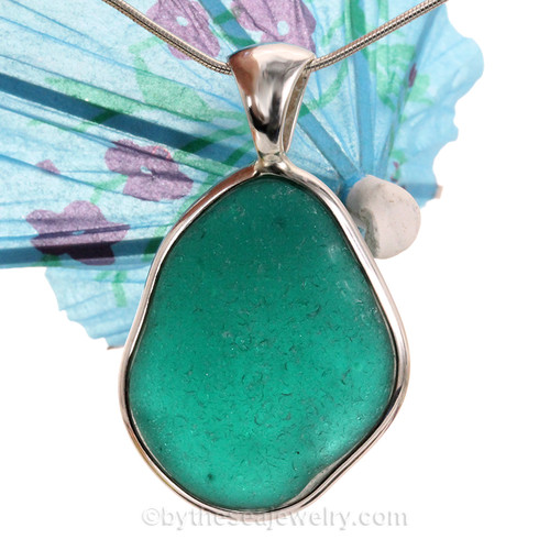  vivid teal sea glass pendant is set in our Deluxe Wire Bezel© pendant setting.