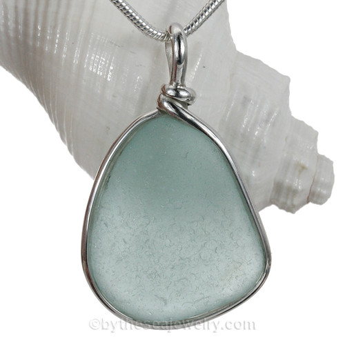 Aqua beach found sea glass from is set in our Original Wire Bezel© pendant setting in sterling silver.