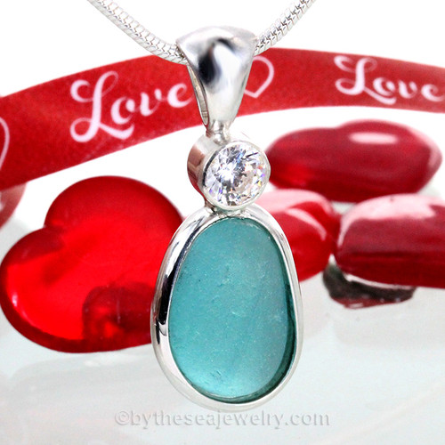 A  small PERFECT of top quality  Aqua Blue  sea glass pendant set with a Premium CZ gem in a tube bezel setting.