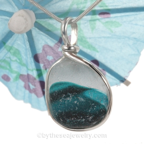 An amazing combination of  mixed aqua medium blue in this very old English Sea Glass piece and set in our Original Wire Bezel© necklace pendant setting. The coloring in the glass resembles a wave! BEAUTIFUL!