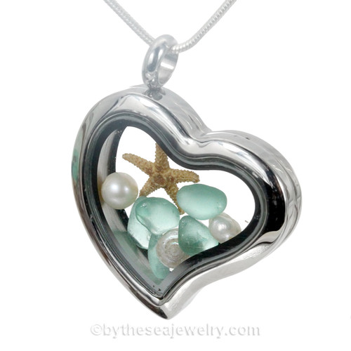 An  Aqua  sea glass pieces in combined with a real shells and tiny pearts ombined a heart locket in this sea glass locket necklace.