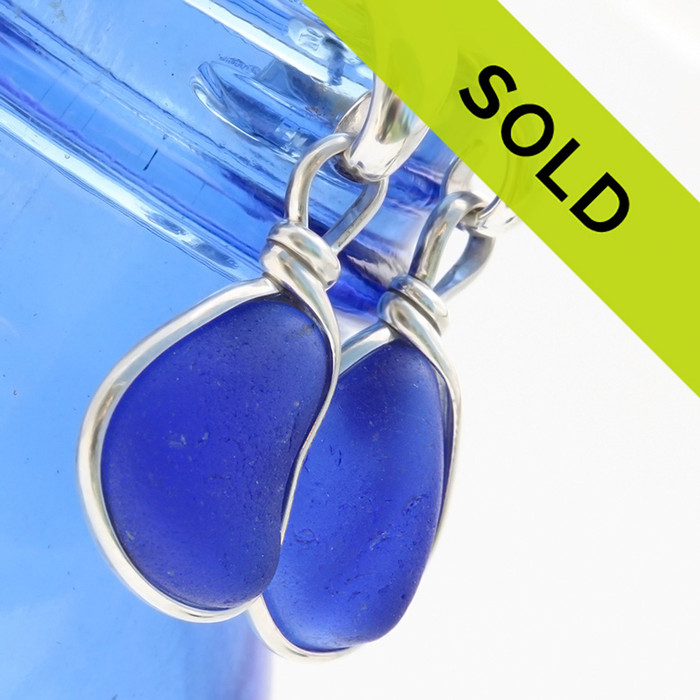 Nicely matched genuine cobalt blue sea glass pieces set in our Original Wire Bezel© setting that leaves the sea glass pieces UNALTERED from the way they were found on the beach. This pair comes on solid sterling curved posts but can easily be switched to other options.
SORRY THIS PAIR HAS SOLD!