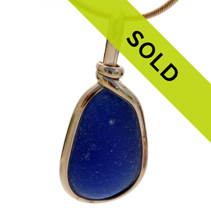 A nice perfect piece of vivid cobalt blue sea glass done in our Original Wire Bezel©2000 setting, it fully secures the glass while leaving both front and back open so you can reach up and feel this antique sea glass. The sea glass piece is left totally UNALTERED from the way it was found on the beach.