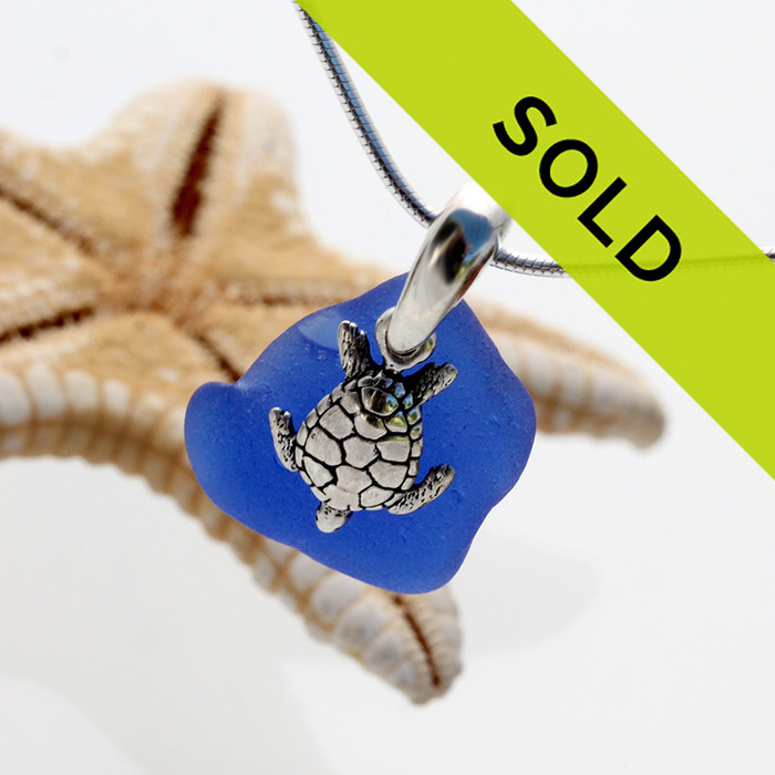 Beach found blue sea glass is combined with a handcast solid sterling bail and finished with a sterling silver sea turtle charm.
This piece has been SOLD!