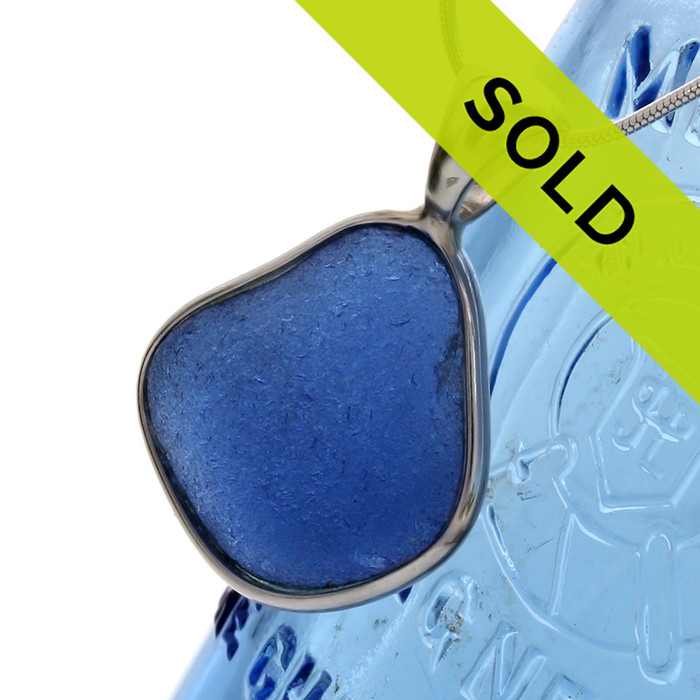 Nice medium vivid blue sea glass set in our Deluxe Wire Bezel© pendant setting for a necklace.