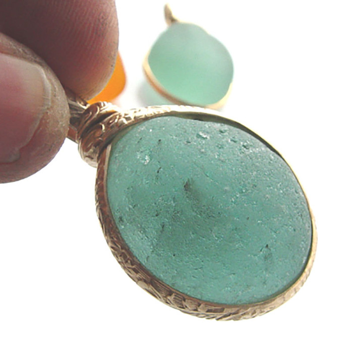 HUGE piece of mixed aqua sea glass from England set in a gold pattern wire bezel setting. The customer wanted a BIG piece! Larger than any we had online!