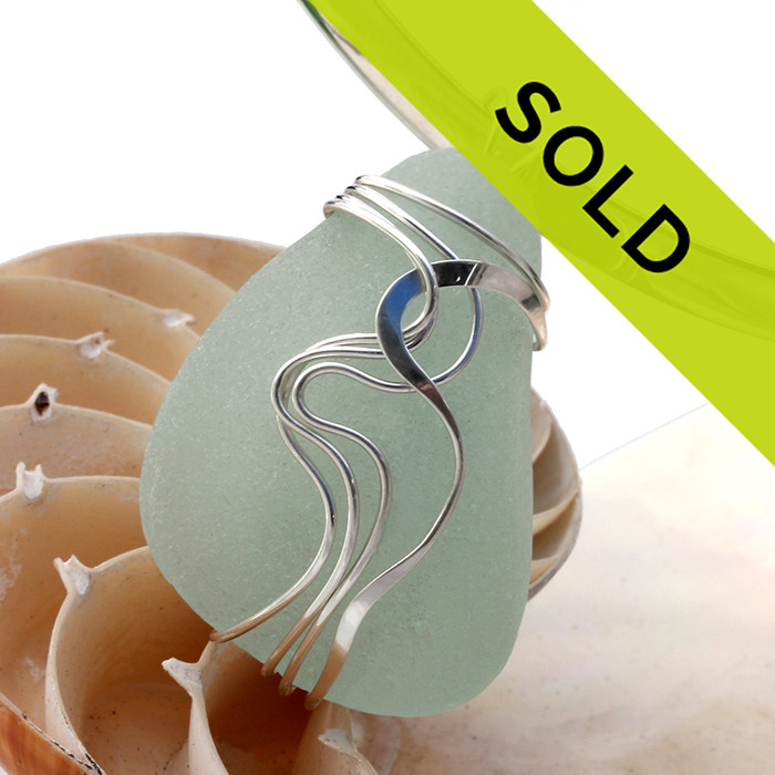 A perfect nicely frosted large curvy piece of sea green sea glass set in our signature Waves©  pendant setting in sterling silver.
This is a large one and shown here with a 6MM sterling collar (not included).