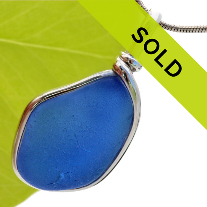 A medium vivid blue sea glass piece set in our Original Wire Bezel© pendant setting.