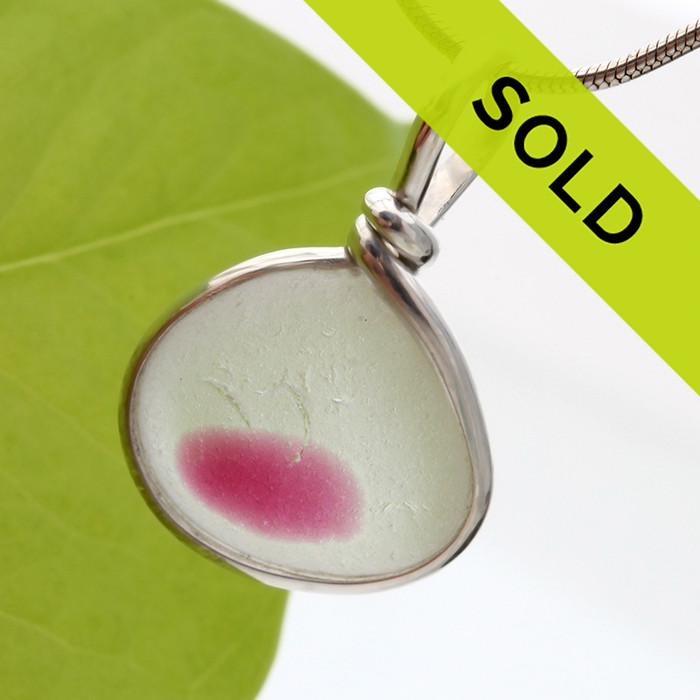 A petite piece of mixed hot pink sea glass from England is set in our Original Wire Bezel© necklace pendant setting.
Sorry this piece has sold!