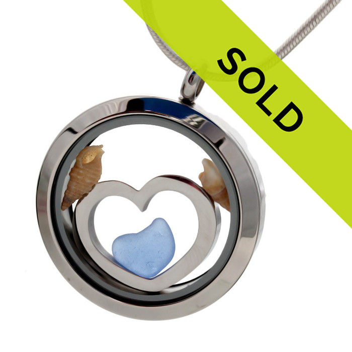 Blue sea glass pieces combined a large silver heart in this sea glass locket necklace.