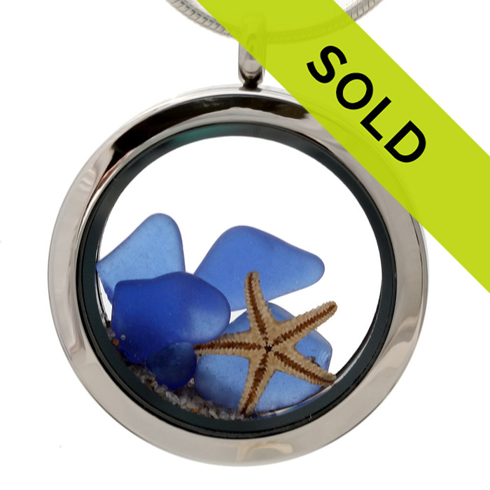 Genuine Blue sea glass pieces combined with a real starfish and beach sand in this sea glass locket necklace.