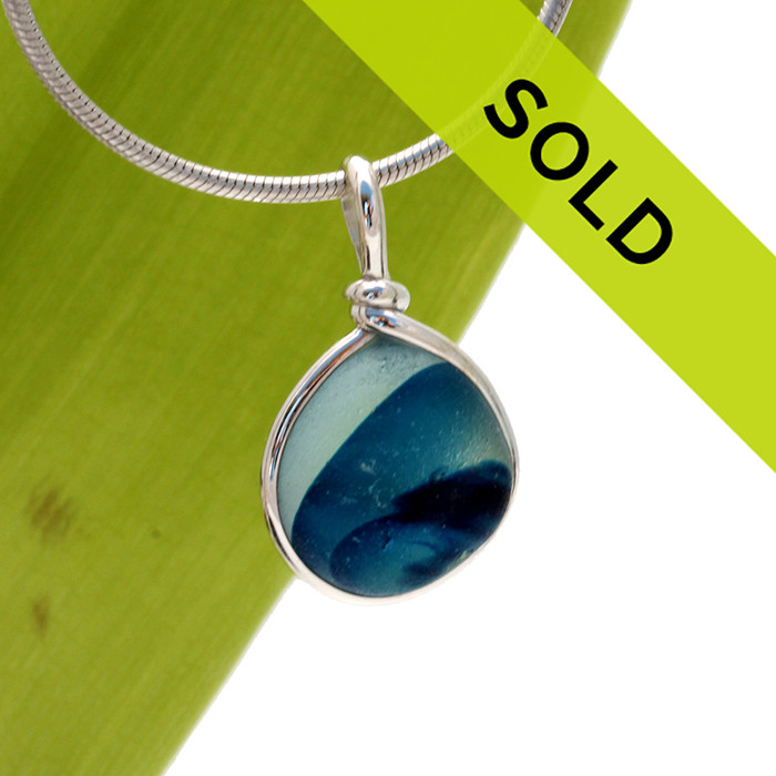 An amazing combination of  mixed aqua medium blue in this very old English Sea Glass piece and set in our Original Wire Bezel© necklace pendant setting. The coloring in the glass resembles a wave! BEAUTIFUL!

SORRY THIS PENDANT HAS SOLD!