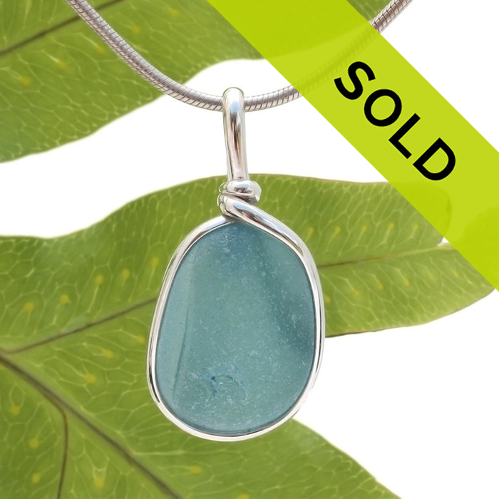 An amazing combination of vivid mixed medium blue in this very old English Sea Glass piece and set in our Original Wire Bezel© necklace pendant setting