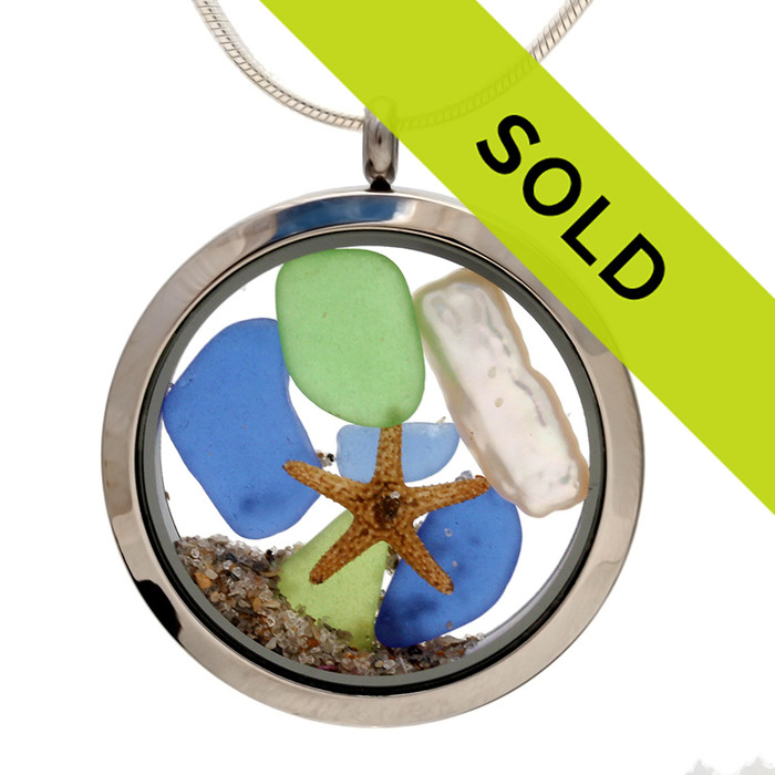 Genuine blue and lime green sea glass combined with a genuine fresh water stick pearl, a tiny starfish and real beach sand in this JUMBO 35MM stainless steel locket.

Pearl is the birthstone for June!