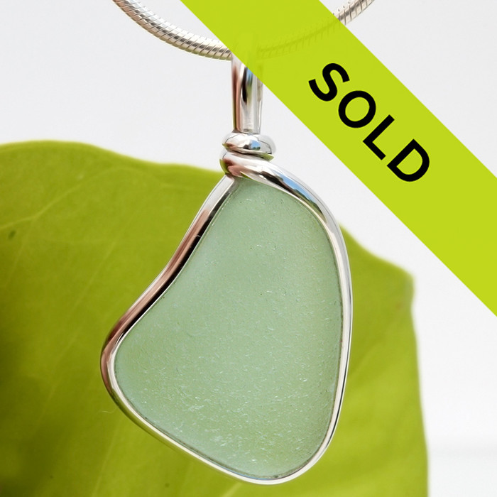 A beautiful piece of seafoam green sea glass set in our Original Wire Bezel pendant setting. This leaves the sea glass piece totally unaltered from the way it was found on the beach!