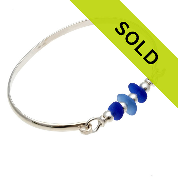 Three pieces of beach found sea glass in light and dark blue on this solid sterling silver half round sea glass bangle bracelet.
Sorry this sea glass jewelry piece has been sold!