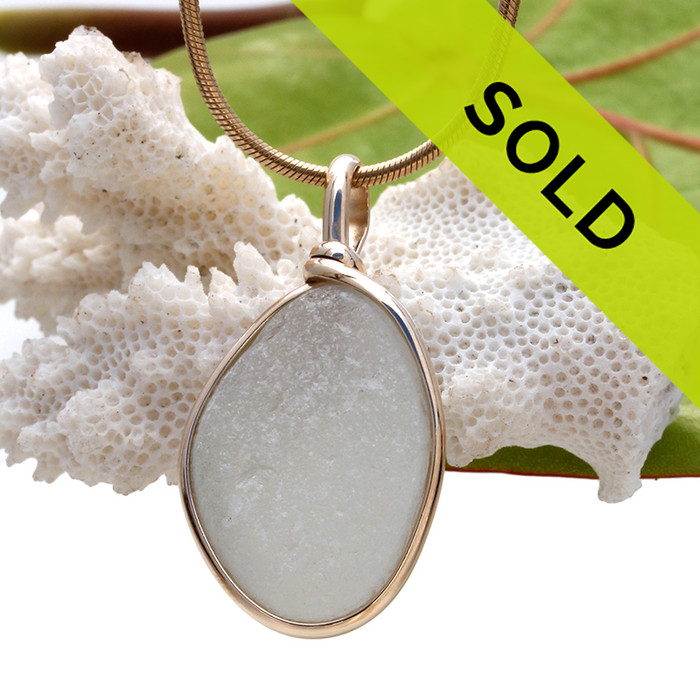 A pure white natural sea glass piece set in our Original Wire Bezel setting in 14K Rolled Gold setting.
Sorry this sea glass pendant has been sold!