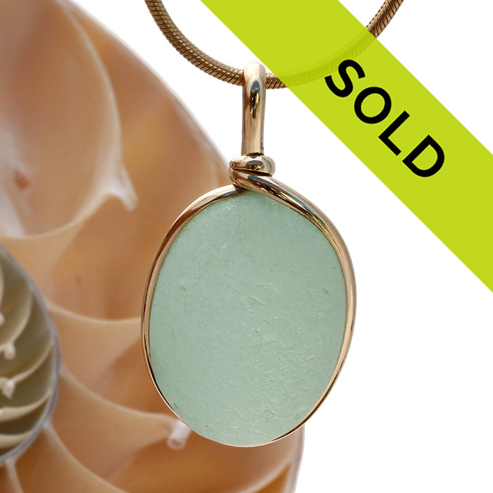 A nice piece of sea green or seafoam green sea glass with in our signature Original Wire Bezel© pendant setting that leaves both front and back open and the glass unaltered from the way it was found on the beach.